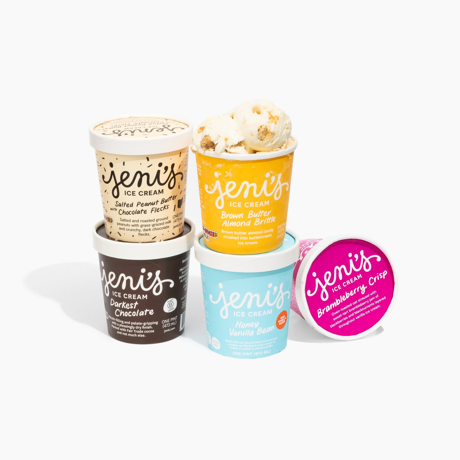 Collection of Jeni's Ice Cream containers in various flavors on a white background