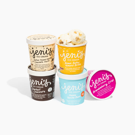 Collection of Jeni's Ice Cream containers in various flavors on a white background